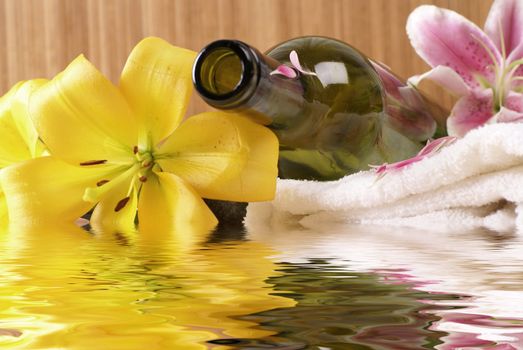 Bottle of massaging oil over spa background           