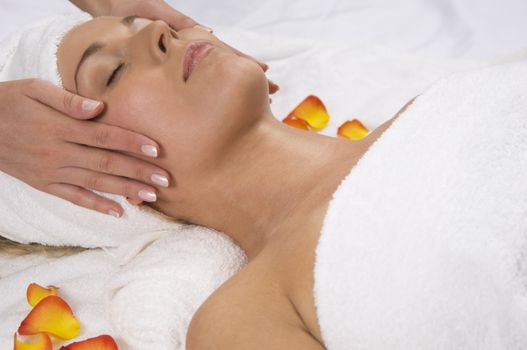 A beautiful woman receiving a facial massage