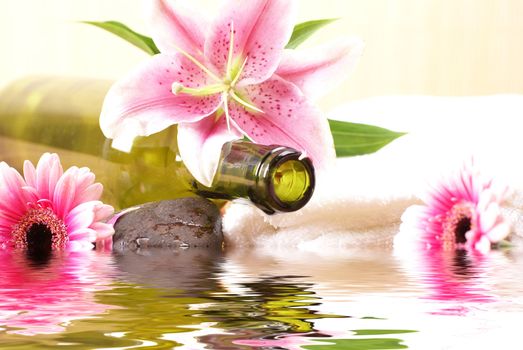 Bottle of massaging oil over spa background           