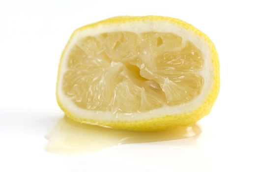 a Squeezed lemon lying in it's on juice