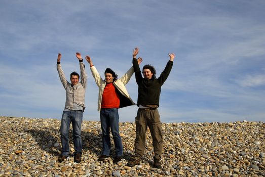 three casual young men at the beach