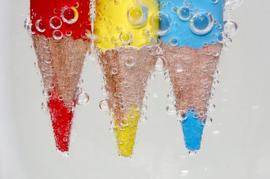 coloured pencil in sparkling water