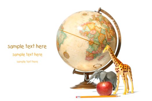 World globe with toy animals and apple on white background