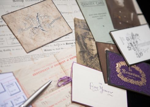 A collection of family artefacts being used to research a family tree.