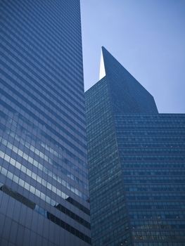 Two skyscrapers against a perfect blue sky.