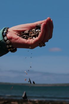 a hand full of earth against a beautiful blue sky