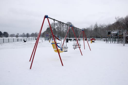 Swings in a plygrond covered in snow