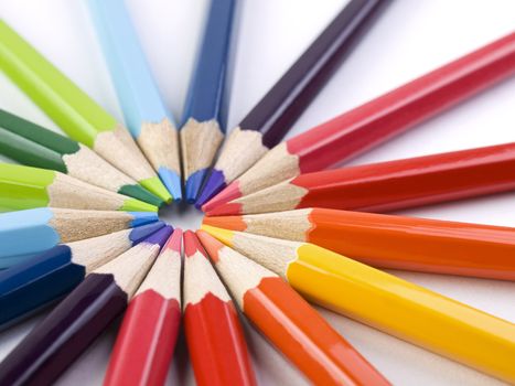 A circle formed by the points of several colored pencils.