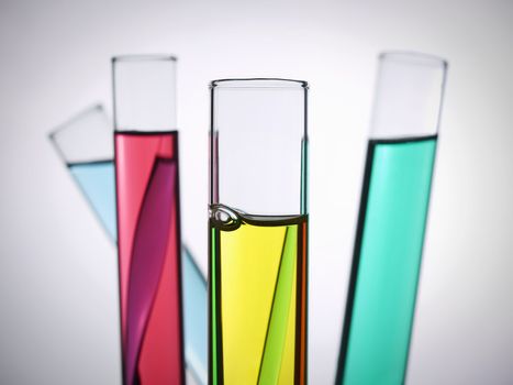 Four test tubes filled with colored liquids.