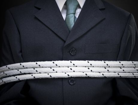 Closeup on the chest of a tied up businessman.