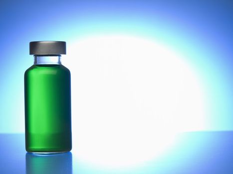 Close up of a vial filled with green liquid. Copy space.