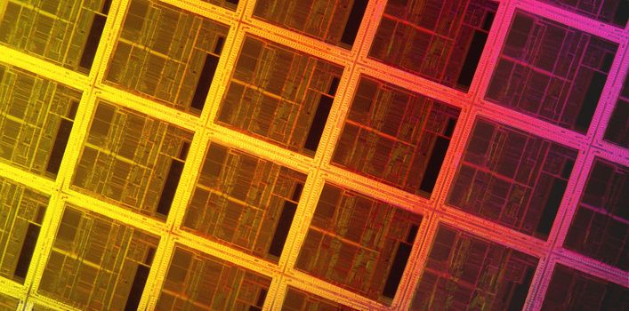 colorful close up of silicon wafer with microprocessors
