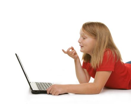 young girl looking and pointing at laptop
