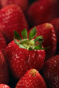 Red summer strawberry with green leaf. Close up.