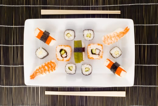 a plate with different kinds of sushi