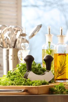 Fresh chopped parsley with bottles of oils 