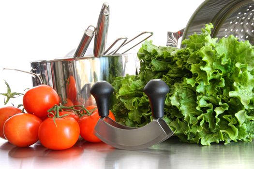 Vegetables with kitchen pots and utensils on white background