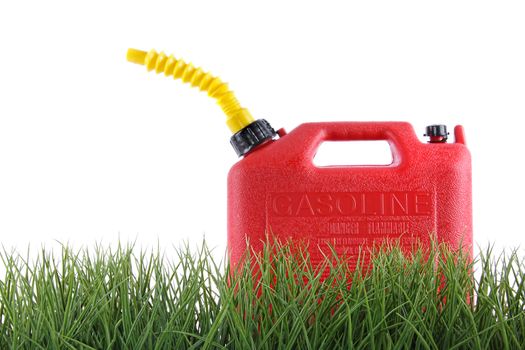 Plastic gas can in grass against white background