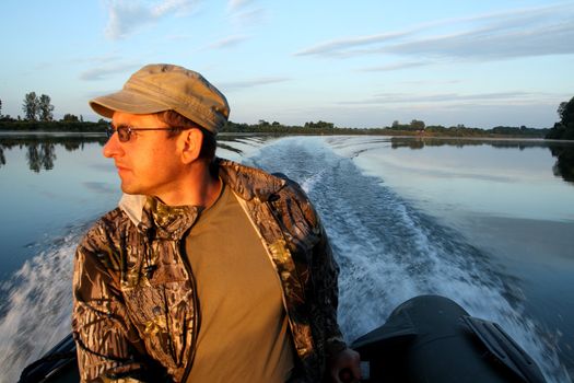 fishing men on inflatable rubber boat with motor