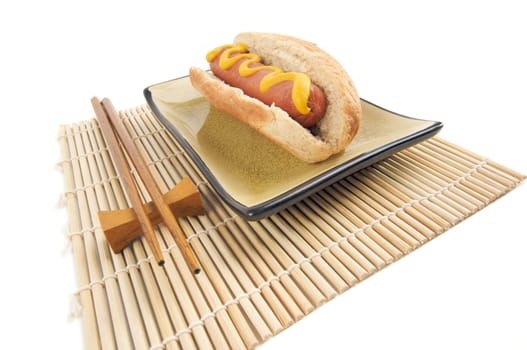 East Meets West - Hot Dog and Chopsticks Isolated on a White Background