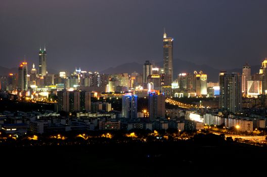 China, Guangdong province, Shenzhen city - night cityscape, general view of Futian and Luohu district with highest skyscrapers and residential buildings.