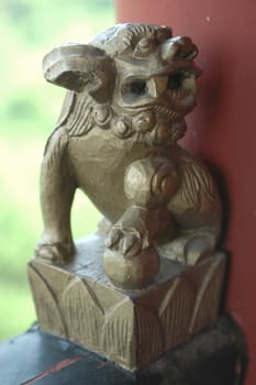 China, Hunan province. Simple decoration, small wooden sculpture showing dragon.