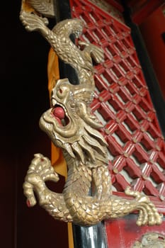 China, Hunan province. Wooden dragon wall sculpture, decoration inside Chinese temple.