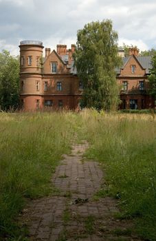 Abandoned old castle, ruins, footpath, green grass