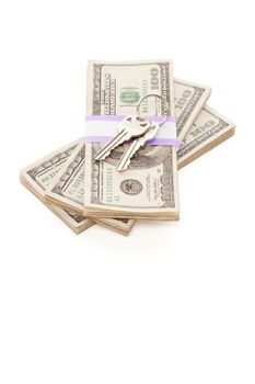 House Keys on Stack of Money Isolated on a White Background - Cash for Keys Program.