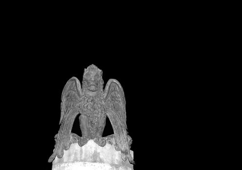 A photograph of a winged lion statue, thought to symbolise strength, swiftness, speed, intelligence, divinity, St Mark, and the city of Venice in Italy. The photograph was taken in Sheffield, England and is isolated on a black background with copy space