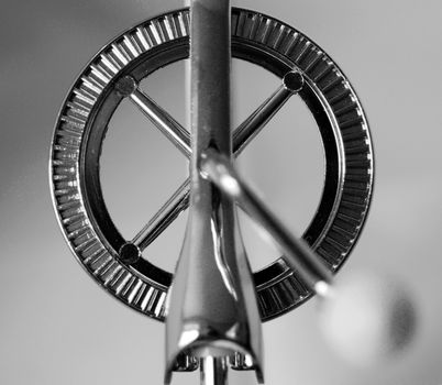 A black and white photograph of the rotor mechanism of a rotary hand whisk