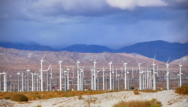 Windmills rotating and producing clean energy, electric power.