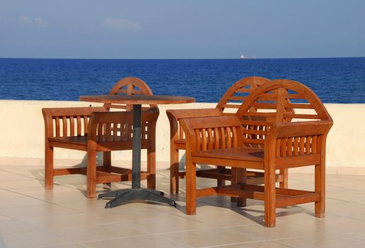 wooden chairs on terrace in summer resort in Turkey by Mediterranean sea