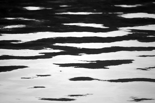 A black and white abstract photograph of ripples of water