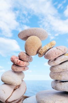 Set of pebbles curved in an arc against the cloudy sky