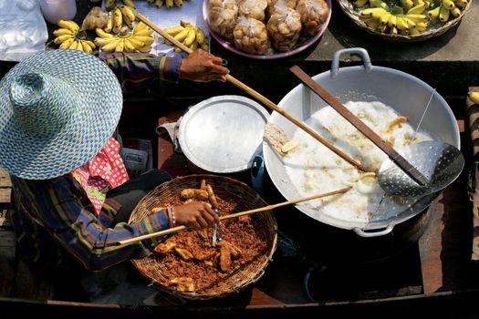 Frying up bananas in the Damnoen Saduak Floating Market in Thailand
