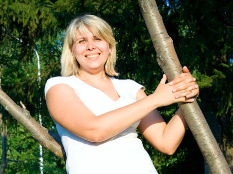 Portrait of the woman against green trees