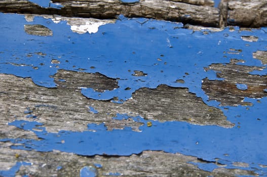 Black and white detail of the peeling paint on the hull of boat