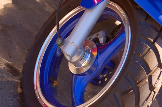 closeup of scooter wheel of blue color