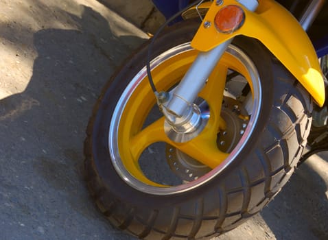 closeup of scooter wheel of yellow color