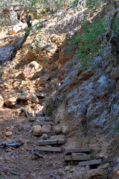 Wooden steps on a nature trail deep slope