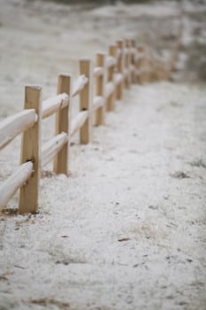 New cedar split rail fence, shot on a winter morning, under a sunless sky.