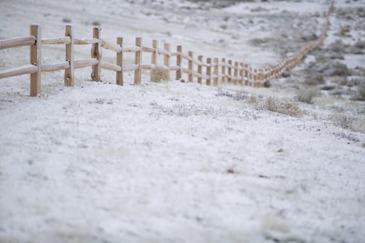 New cedar split rail fence, shot on a winter morning, under a sunless sky.