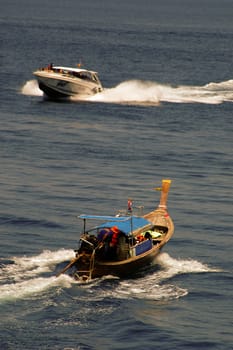 Tailboat and speedboat.