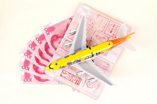 Small toy plane, passport full of stamps from Hongkong and Chinese money, RMB banknotes.