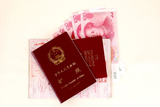 Chinese and European passport, stamps from borders and Chinese banknotes.