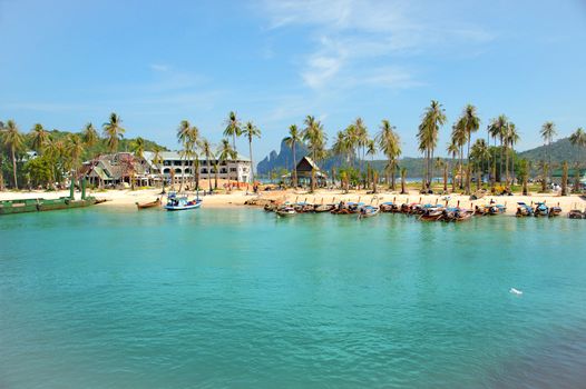 A beuatifu beach with boats and palmtrees