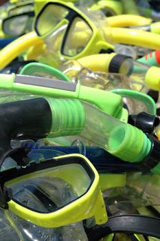 A pile off diver masks and snorkels