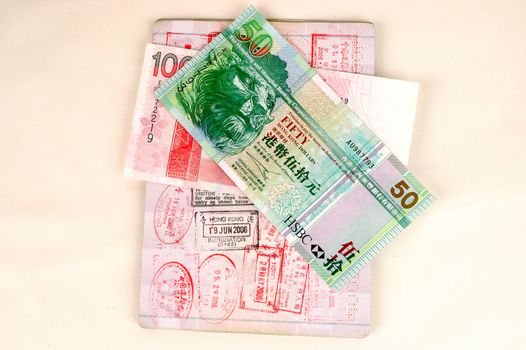 European passport, Chinese passport, stamps from Hongkong and China borders together with Hongkong dollars banknotes.