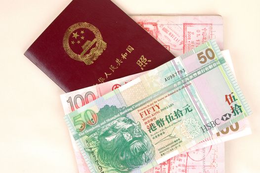 European passport, Chinese passport, stamps from Hongkong and China borders together with Hongkong dollars banknotes.